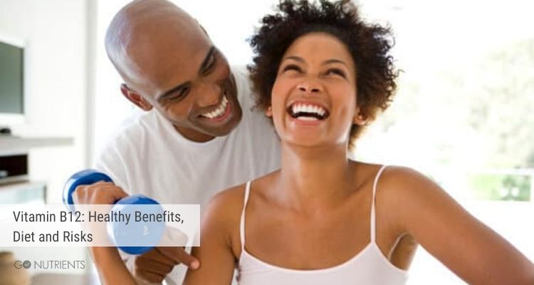 Man and woman laughing.  She is holding an exercise weight.  Vitamin B12 plays a role in good health. 