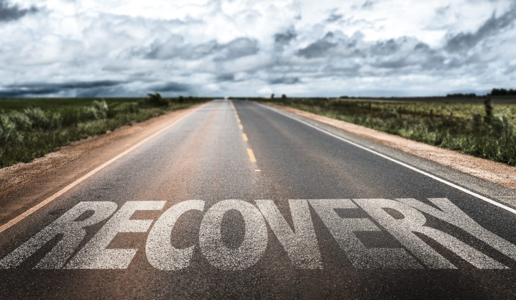 A road with the word "Recovery" painted on the image. 