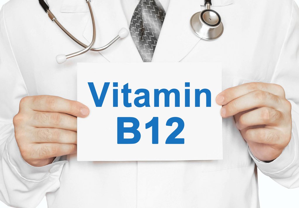 Doctor holding a card with Vitamin B12, Medical concept