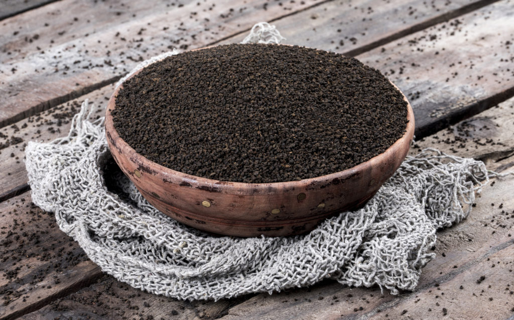 Fresh Aromatic Black Tea Loose or Dried Tea Leaves on Wooden Table