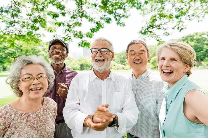 Seniors outside laughing and enjoying life.  Healthy and without vitamin B12 deficiency. 