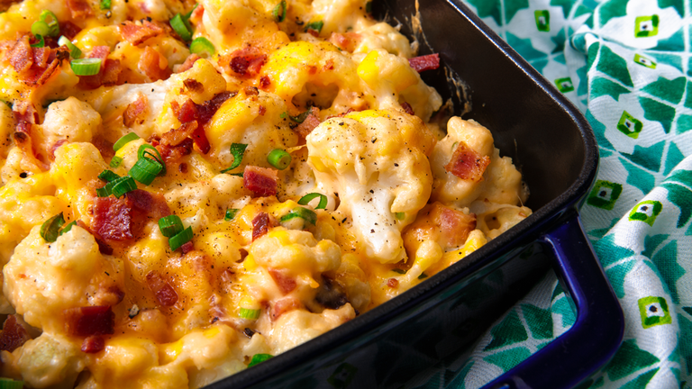 Loaded cauliflower bake in a baking dish and ready to serve.