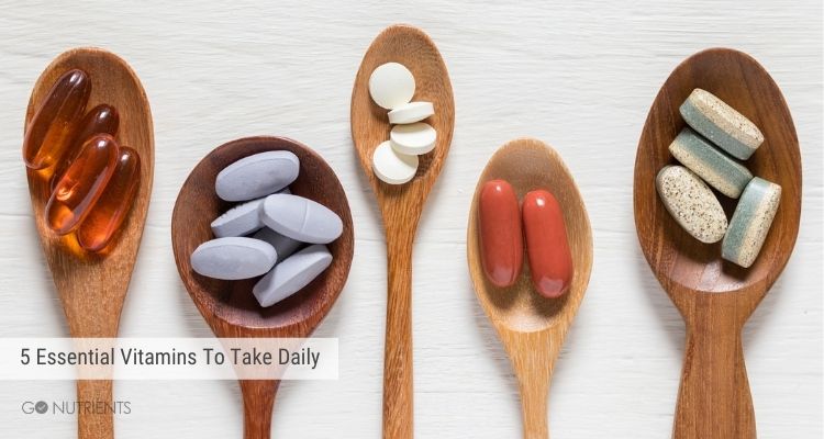 5 Essential Vitamins You Should Take Daily - A photo of 5 wooden spoons with various vitamins in them.