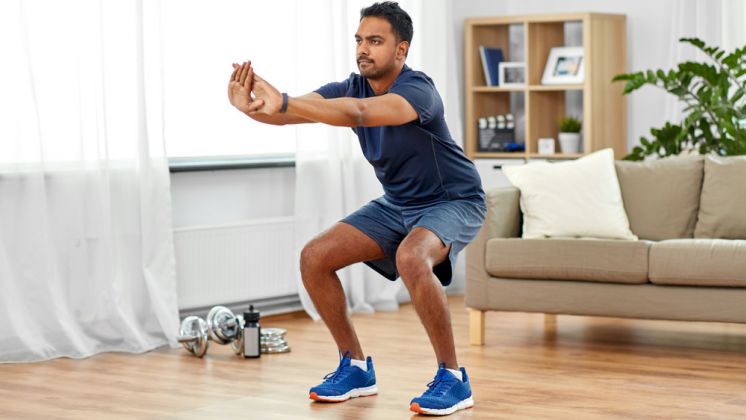man demonstrating a squat