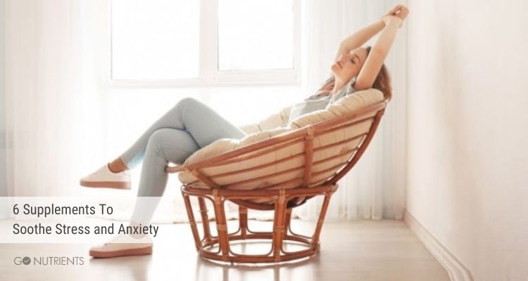 Woman relaxing in a chair with arms stretched out over her head - Stress and anxiety 