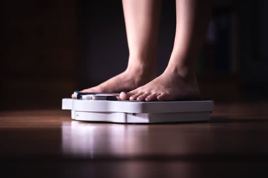 Person's feet shown standing on a scale